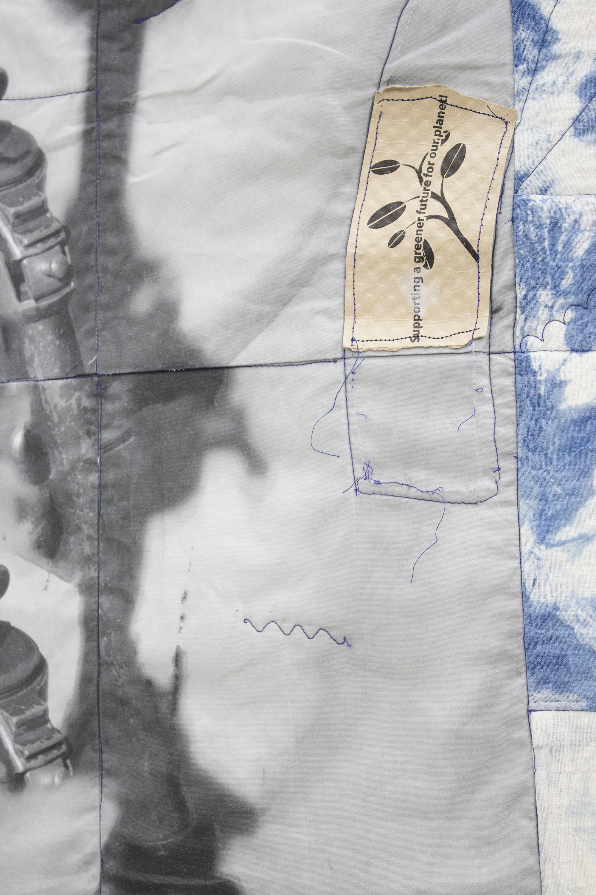 Erin Jane Nelson Dullup (Detail), 2014 ￼￼Inkjet on cotton, indigo-dyed muslin, 5XL t- shirt, contents of a USB cord,  silk ribbon, iron- on patch, dragon claw studs, coffee cozy, and quilt batting