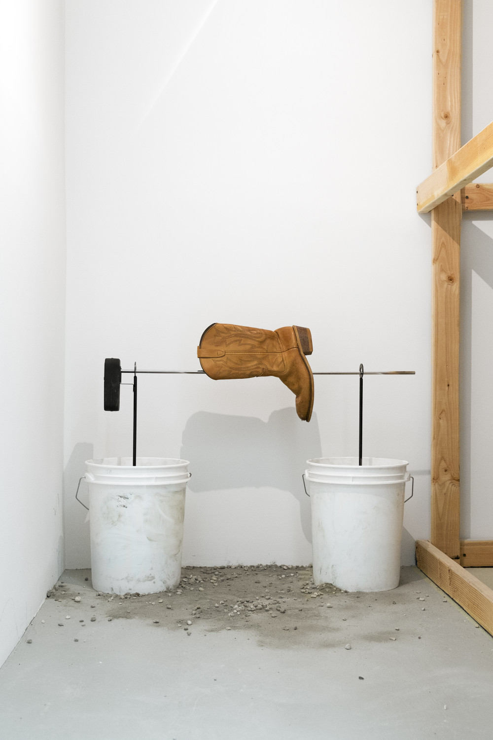 Quintessa Matranga Ask the Dust, 2016 Buckets, concrete, outdoor spit rotisserie, batteries, and leather boot. Dimensions variable
